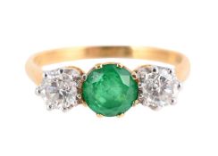 AN EMERALD AND DIAMOND THREE STONE RING