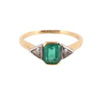 AN EMERALD AND DIAMOND THREE STONE RING