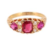 A DIAMOND AND RED STONE RING