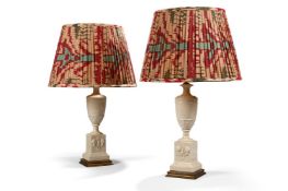 A PAIR OF GILT METAL AND CREAM COLOURED POTTERY MOUNTED URNS ADAPTED AS LAMPS, 20TH CENTURY