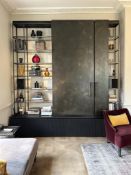 A BRONZED AND PATINATED METAL MEDIA CABINET, BY LOUISE BRADLEY, OF RECENT MANUFACTURE