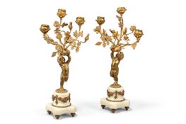 A PAIR OF GILT BRONZE AND WHITE MARBLE FIGURAL THREE LIGHT CANDELABRA, FRENCH, LATE 19TH CENTURY
