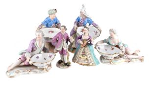 A PAIR OF MEISSEN (OUTSIDE DECORATED) FIGURAL SALTS, LATE 19TH CENTURY, AND FOUR MORE FIGURES