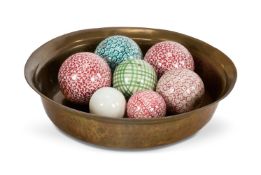 A BRASS BOWL WITH CARPET BOWLS, 19TH CENTURY