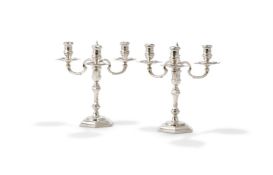A PAIR OF CAST SILVER THREE LIGHT CANDELABRA