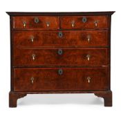 A GEORGE I FIGURED WALNUT AND FEATHERBANDED CHEST OF DRAWERS, CIRCA 1725