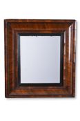A WILLIAM & MARY FIGURED WALNUT 'CUSHION' FRAME MIRROR, CIRCA 1690