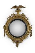 A REGENCY CARVED GILTWOOD CONVEX GIRANDOLE MIRROR, CIRCA 1815