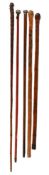TWO JAPANESE CARVED BAMBOO WALKING STICKS, MEIJI PERIOD, CIRCA 1890-1900, AND THREE FURTHER EXAMPLES