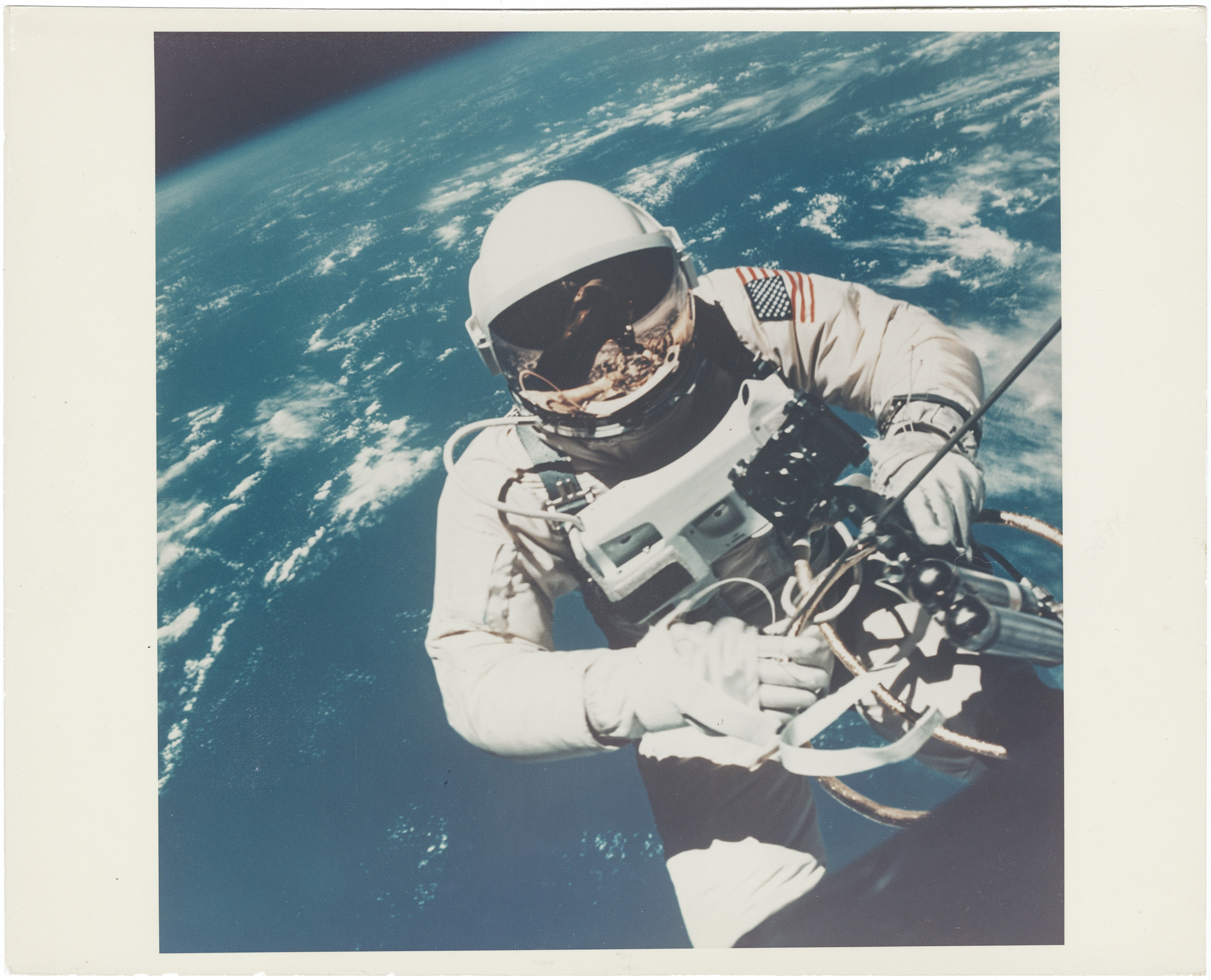 [Gemini IV] THE FIRST PHOTOGRAPH OF A HUMAN IN SPACE TAKEN DURING THE FIRST U.S. SPACEWALK