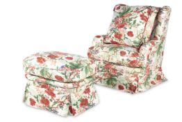 A CHINTZ UPHOLSTERED WING ARMCHAIR AND MATCHING FOOTSTOOL, BY SIBYL COLEFAX AND JOHN FOWLER