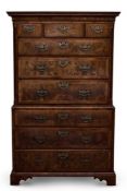 A GEORGE II FIGURED WALNUT AND FEATHERBANDED TALLBOY, CIRCA 1730