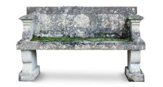 A CARVED LIMESTONE GARDEN BENCH, PROBABLY ITALIAN