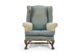 A LARGE MAHOGANY AND UPHOLSTERED WINGBACK ARMCHAIR, CIRCA 1900