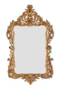AN ITALIAN CARVED GILTWOOD AND ENGRAVED GLASS MIRROR, EARLY 20TH CENTURY