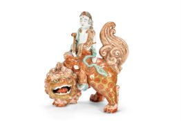 A KUTANI PORCELAIN MODEL OF BODHISATTVA SHISHI AND MONJO BOSATSO SEATED ON A SHISHI, JAPANESE