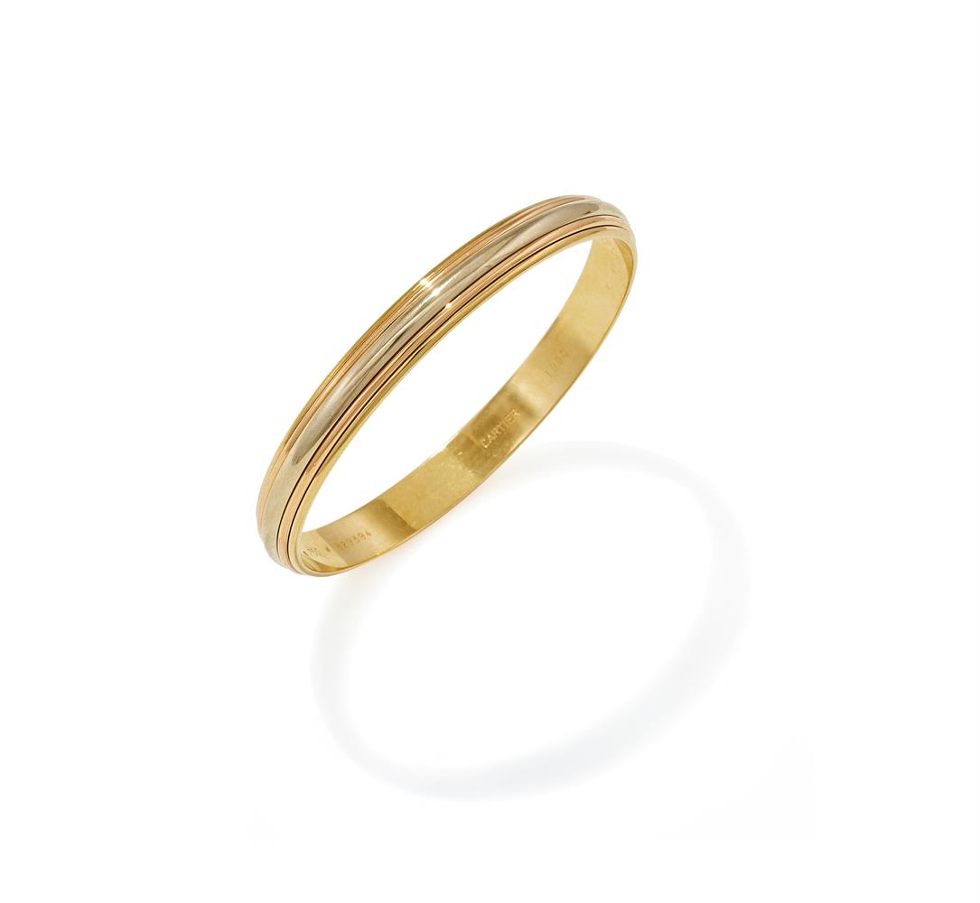 CARTIER, AN 18CT TRI-COLOURED GOLD BANGLE