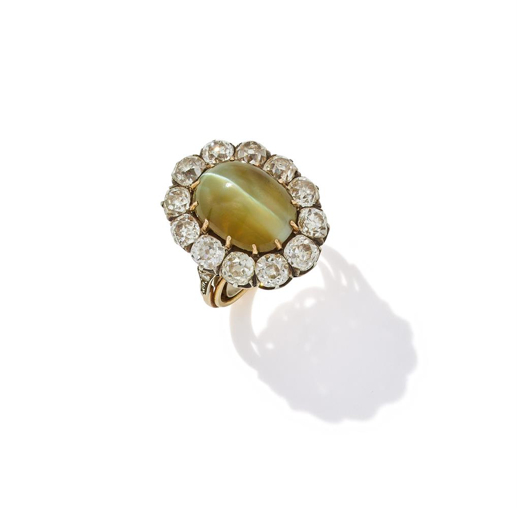 A CAT'S EYE CHRYSOBERYL AND DIAMOND CLUSTER RING
