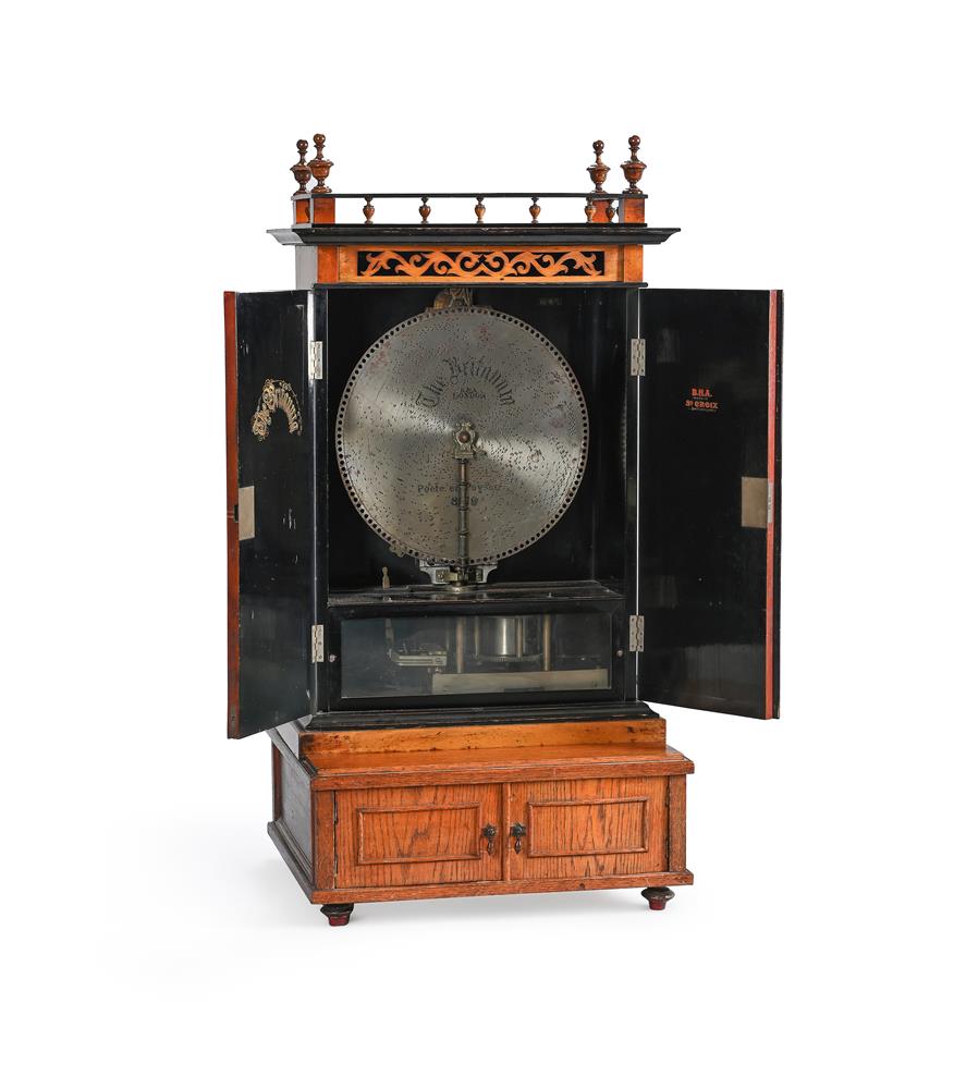 A WALNUT VERTICAL BUFFET-TYPE CABINET SEVENTEEN INCH DISC MUSIC BOX