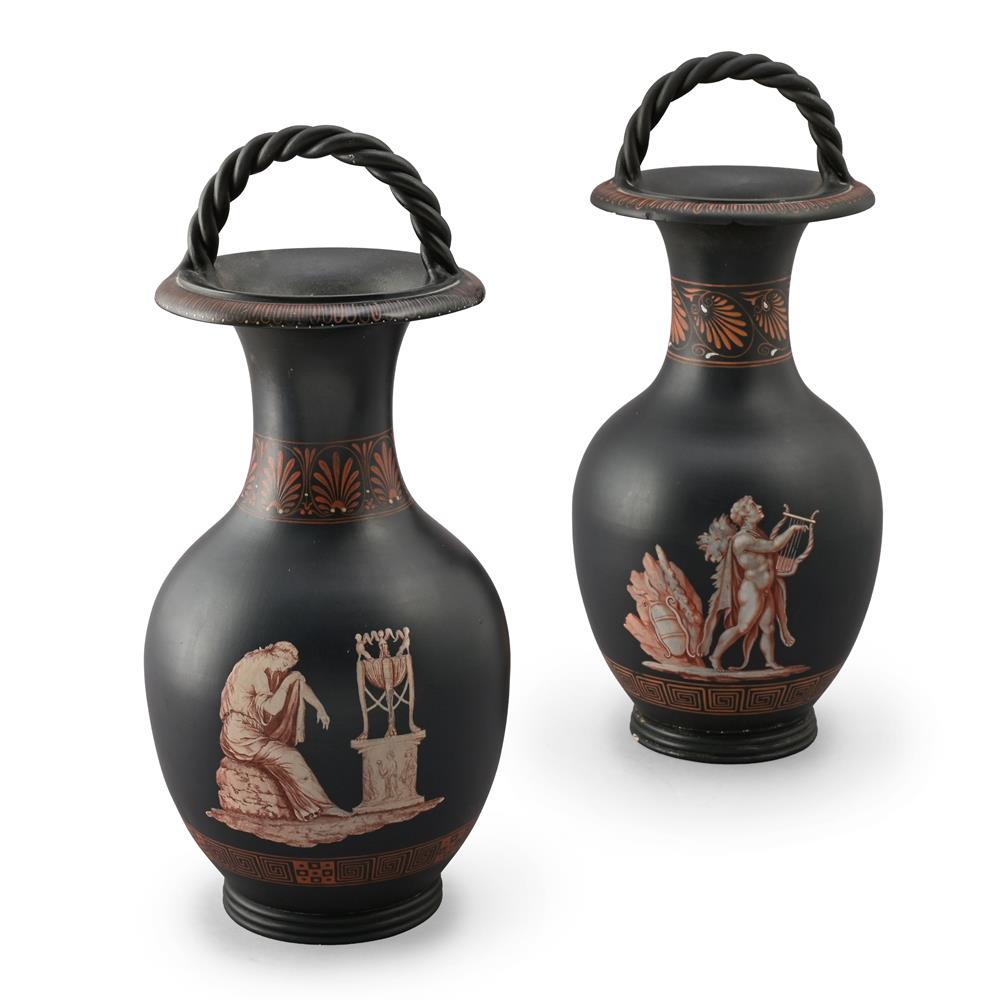 A PAIR OF ENGLISH BLACK POTTERY ENCAUSTIC DECORATED VASES WITH A ROPE-TWIST HANDLE