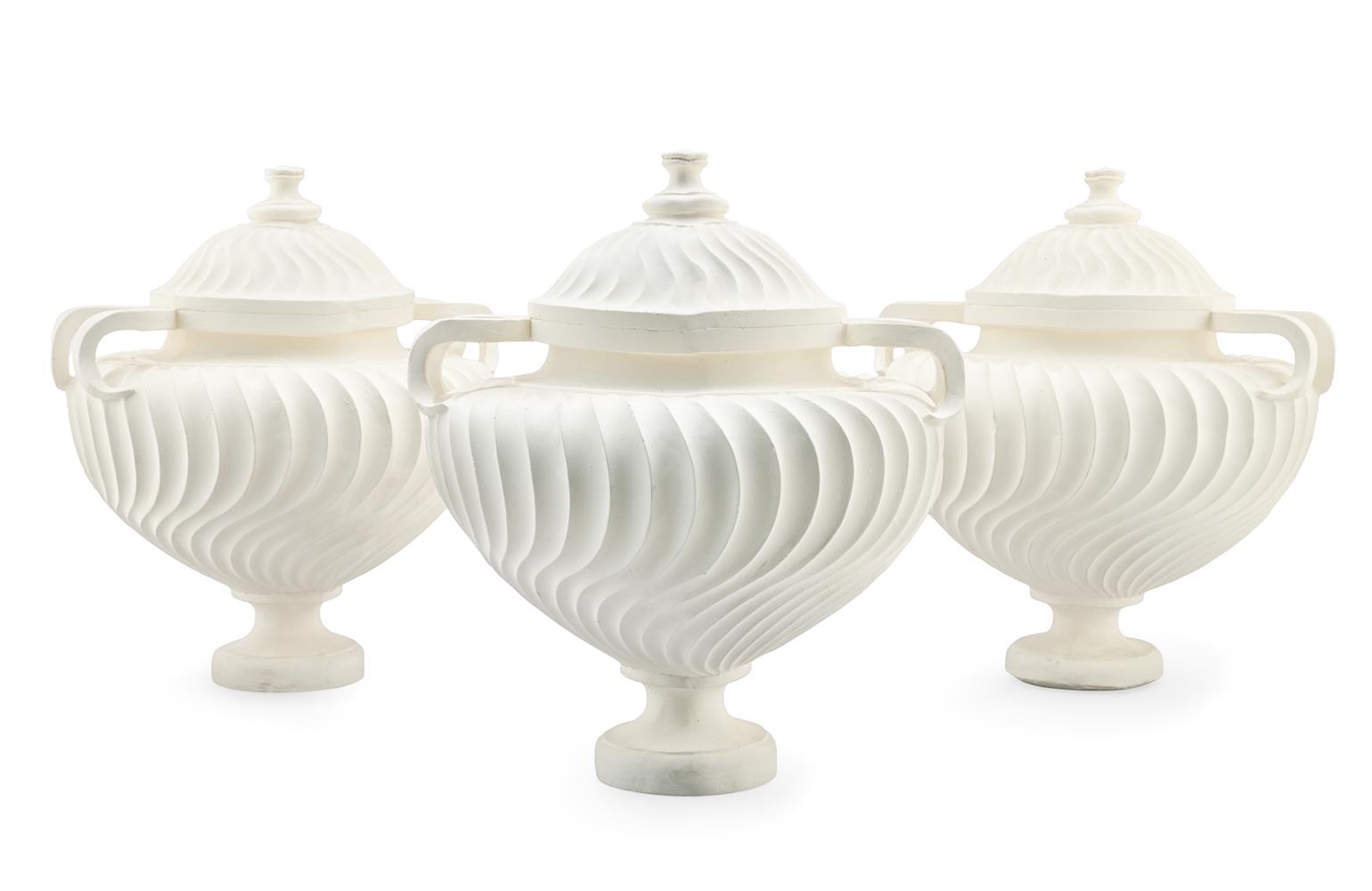 A SET OF THREE TWO HANDLED PLASTER 'PIRANESI' URNS, BY SOANE