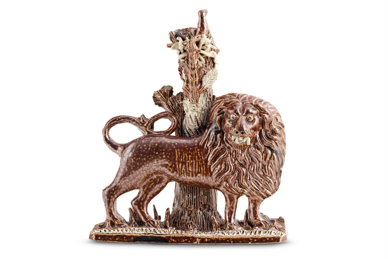 AN ENGLISH BROWN SALT-GLAZED STONEWARE BOCAGE MODEL OF A LION PASSANT, PROBABLY DERBYSHIRE