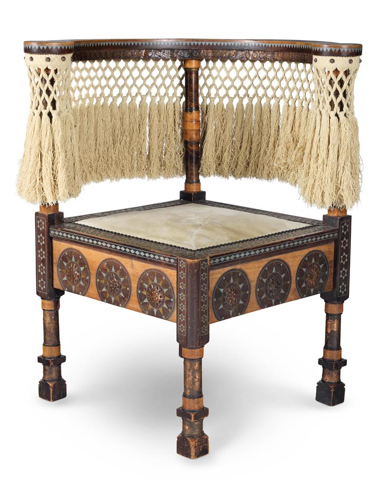A CORNER CHAIR WITH BRASS AND PEWTER INLAY, CARVED AND REPOUSSÉ DECORATION BY CARLO BUGATTI
