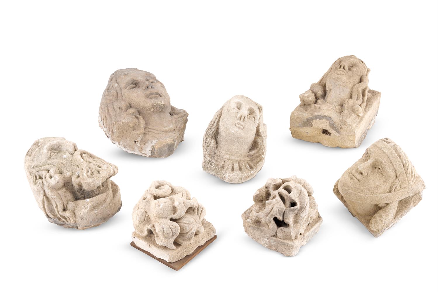 A GROUP OF SEVEN CARVED STONE CORBELS AND BOSSES, BY TRADITION FROM BRUTON ABBEY