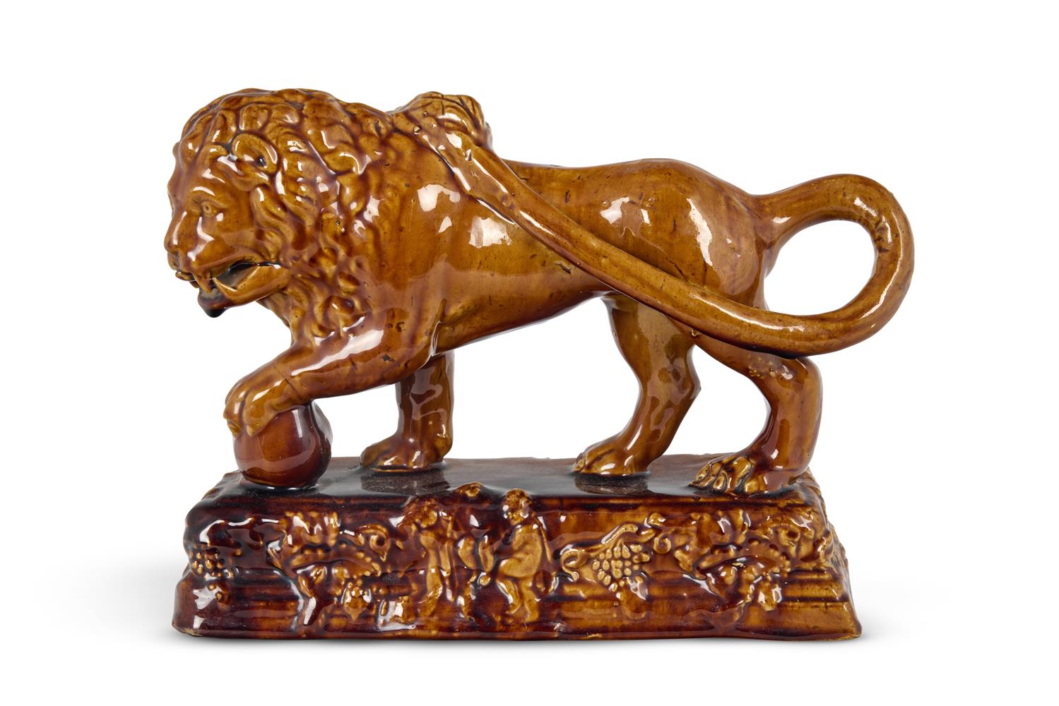 A STAFFORDSHIRE TREACLE-GLAZED POTTERY MODEL OF A MEDICI LION, MID 19TH CENTURY