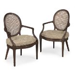 A PAIR OF GEORGE III MAHOGANY LIBRARY ARMCHAIRS, IN THE MANNER OF THOMAS CHIPPENDALE, CIRCA 1790
