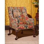 A FINE GEORGE II CARVED MAHOGANY AND NEEDLEWORK UPHOLSTERED WING ARMCHAIR, CIRCA 1740