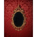 A GEORGE III CARVED GILTWOOD MIRROR, IN THE MANNER OF THOMAS CHIPPENDALE, CIRCA 1770