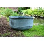 A VERY LARGE PATINATED COPPER AND RIVETED CIRCULAR PLANTER, CONTEMPORARY