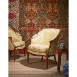 A PAIR OF GEORGE III MAHOGANY AND SILK DAMASK UPHOLSTERED BERGERE ARMCHAIRS, CIRCA 1790