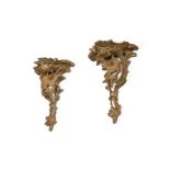 A PAIR OF GEORGE III CARVED AND OCHRE PAINTED WALL BRACKETS, CIRCA 1770