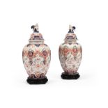 A PAIR OF DELFT POLYCHROME HEXAGONAL SECTION VASES AND COVERS, LATE 19TH CENTURY