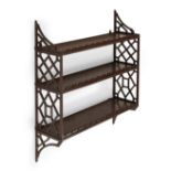 A FLIGHT OF GEORGE III MAHOGANY 'CHINESE CHIPPENDALE' FRETWORK HANGING SHELVES, CIRCA 1780