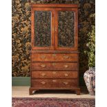 A GEORGE II WALNUT AND FEATHERBANDED SECRETAIRE CABINET ON CHEST, CIRCA 1730