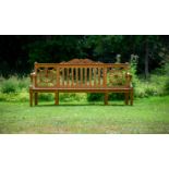 A CARVED TEAK 'HAREWOOD' GARDEN BENCH, IN THE MANNER OF THOMAS CHIPPENDALE, CONTEMPORARY