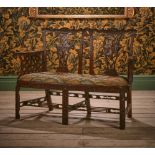 A GEORGE III CARVED MAHOGANY CHAIR BACK SETTEE, IN THE MANNER OF THOMAS CHIPPENDALE, CIRCA 1770