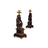 A PAIR OF REGENCY GILT AND PATINATED BRONZE NEO-EGYPTIAN CANDLESTICKS