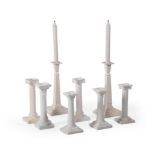 A PAIR OF ENGLISH CREAMWARE COLUMNAR CANDLESTICKS, LATE 20TH CENTURY, WITH SIX SIMILAR EXAMPLES