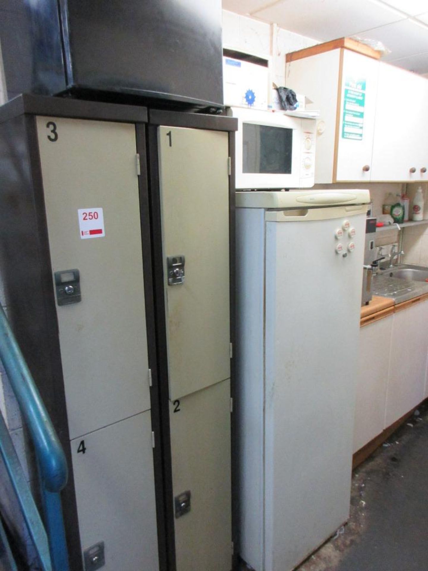 Two metal 2-door personnel lockers, LEC fridge, toaster, kettle, microwave, counter top fridge