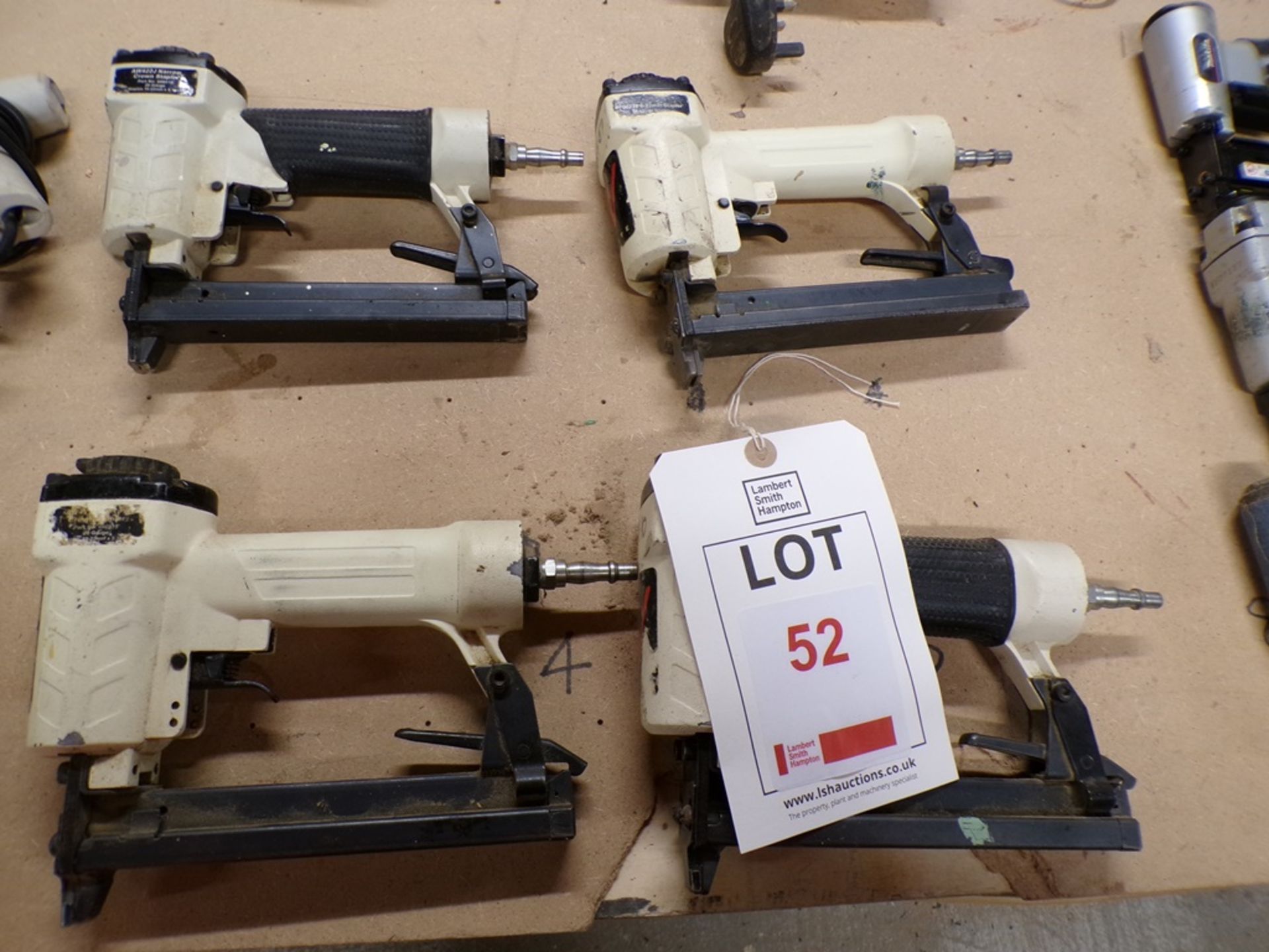 Four white pneumatic staplers