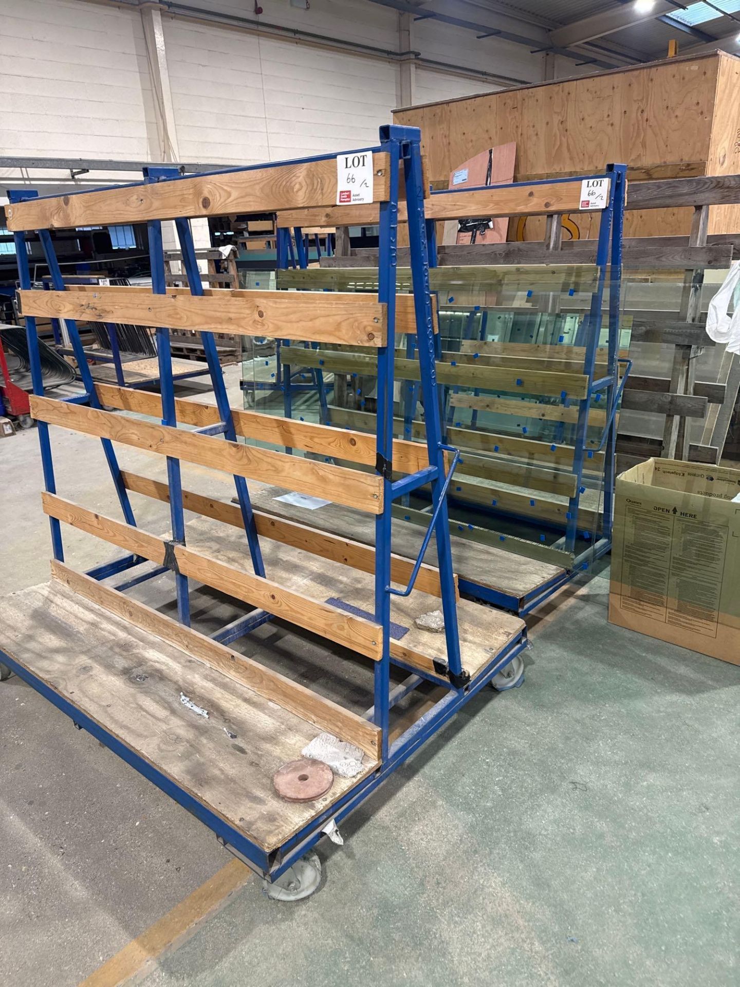 Two various steel framed mobile glass carts