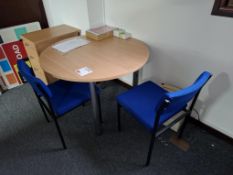 Circular table and two blue cloth upholstered chairs