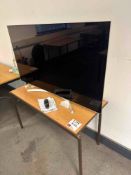 LG OLED55B7V-Z OLED flat screen TV with remote and table