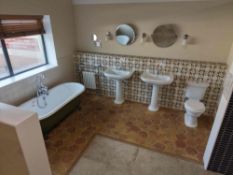 Display bathroom to include roll top bath, toilet, two sinks, towel warmer and accessories as lotted