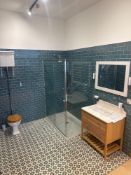 Display shower room to include glass shower unit, toilet, one towel rail, sink, and accessories