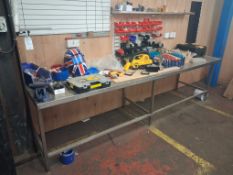 Assorted stainless steel workbenches including loose and removable contents on and under tables